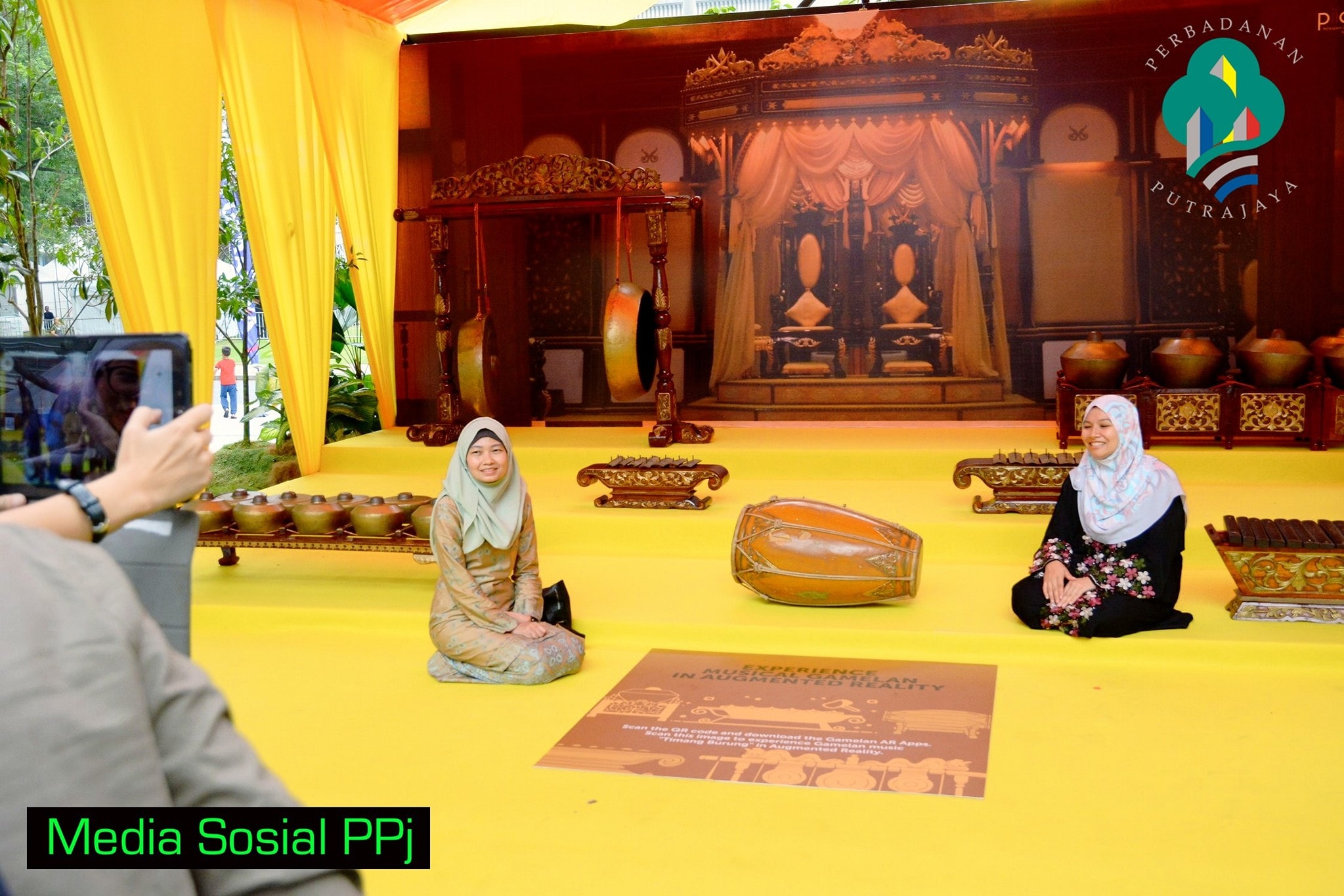 Visitors using a tablet at the Putrajaya augmented reality gamelan exhibition